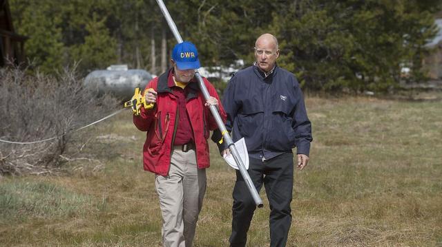 State employee Frank Gehrke and then-Gov. Jerry Brown walk through Carol Pearson’s drought-plagued meadow near Echo Summit in April 2015. This year’s April snowpack could approach low levels.